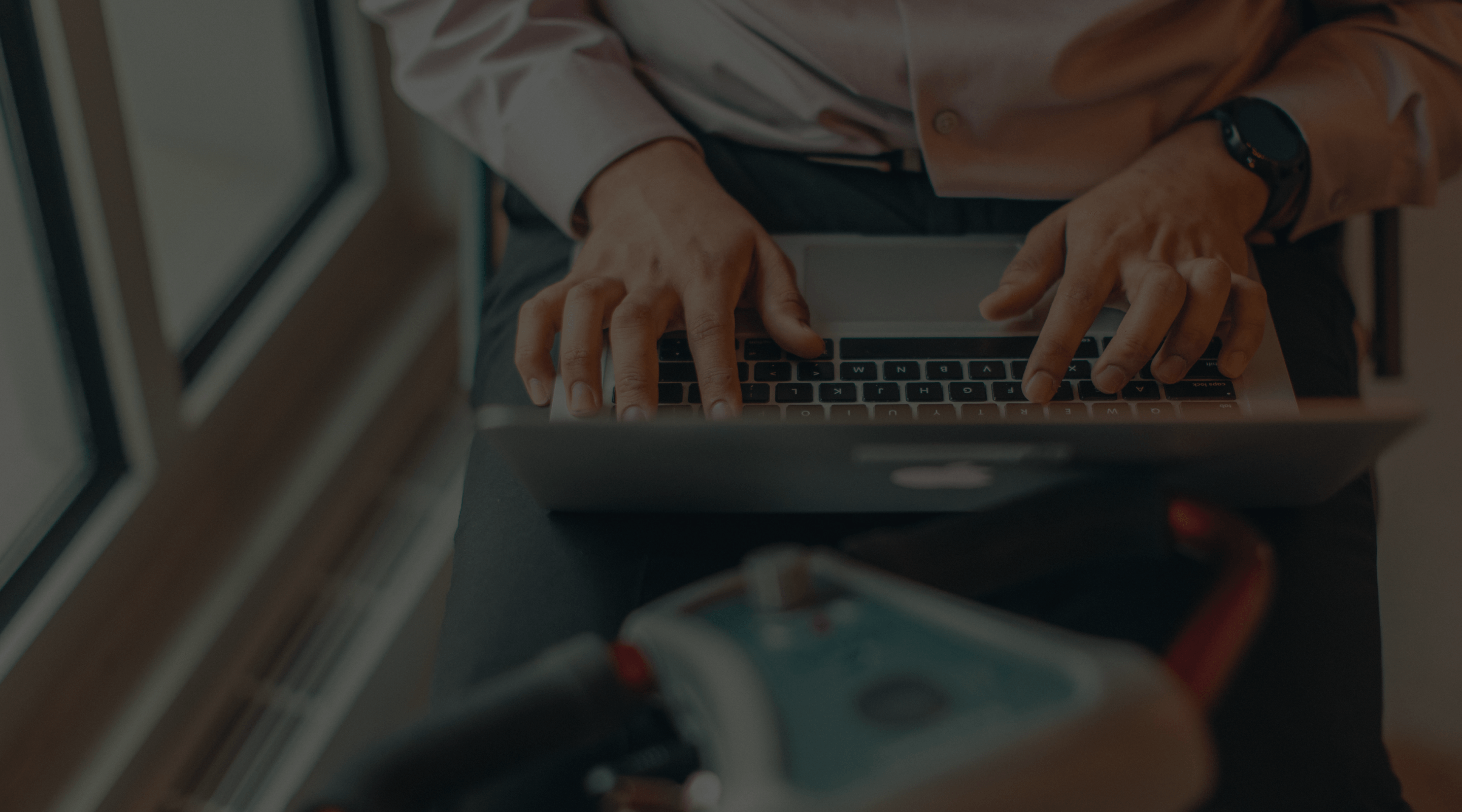 Close up shot of man typing on laptop on his motorized scooter.