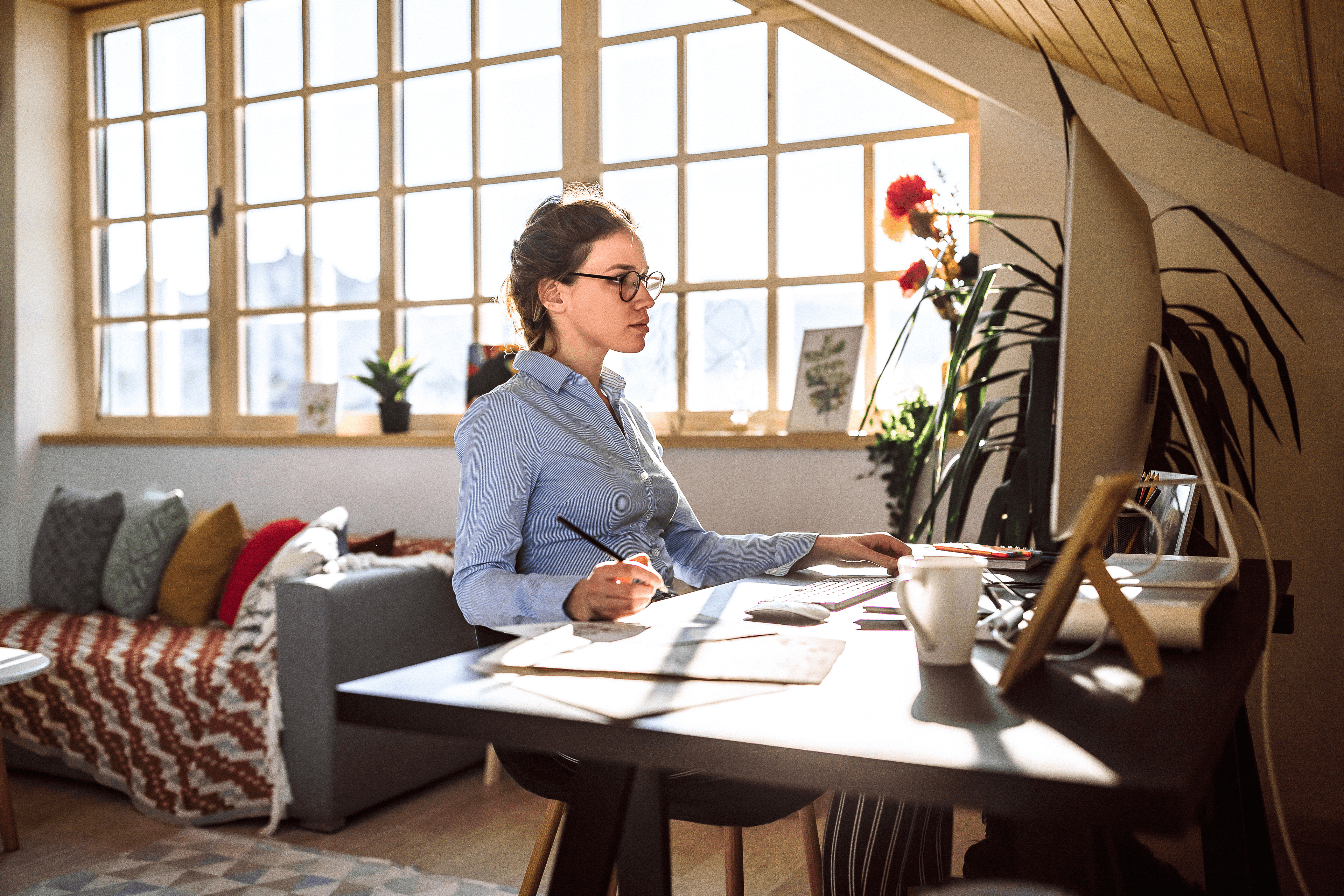 A woman working from home at her desk.