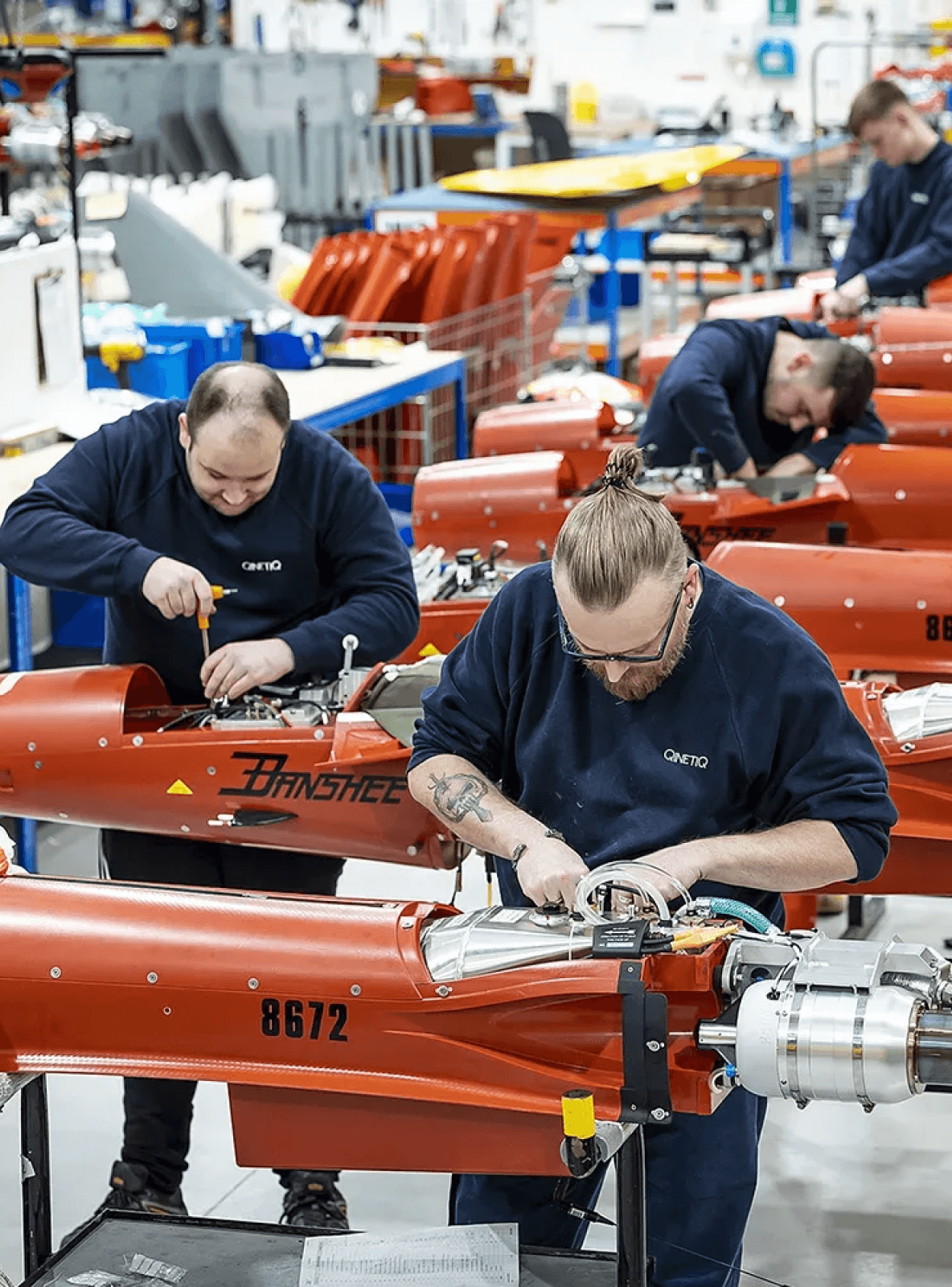 Image of two people working in a factory.