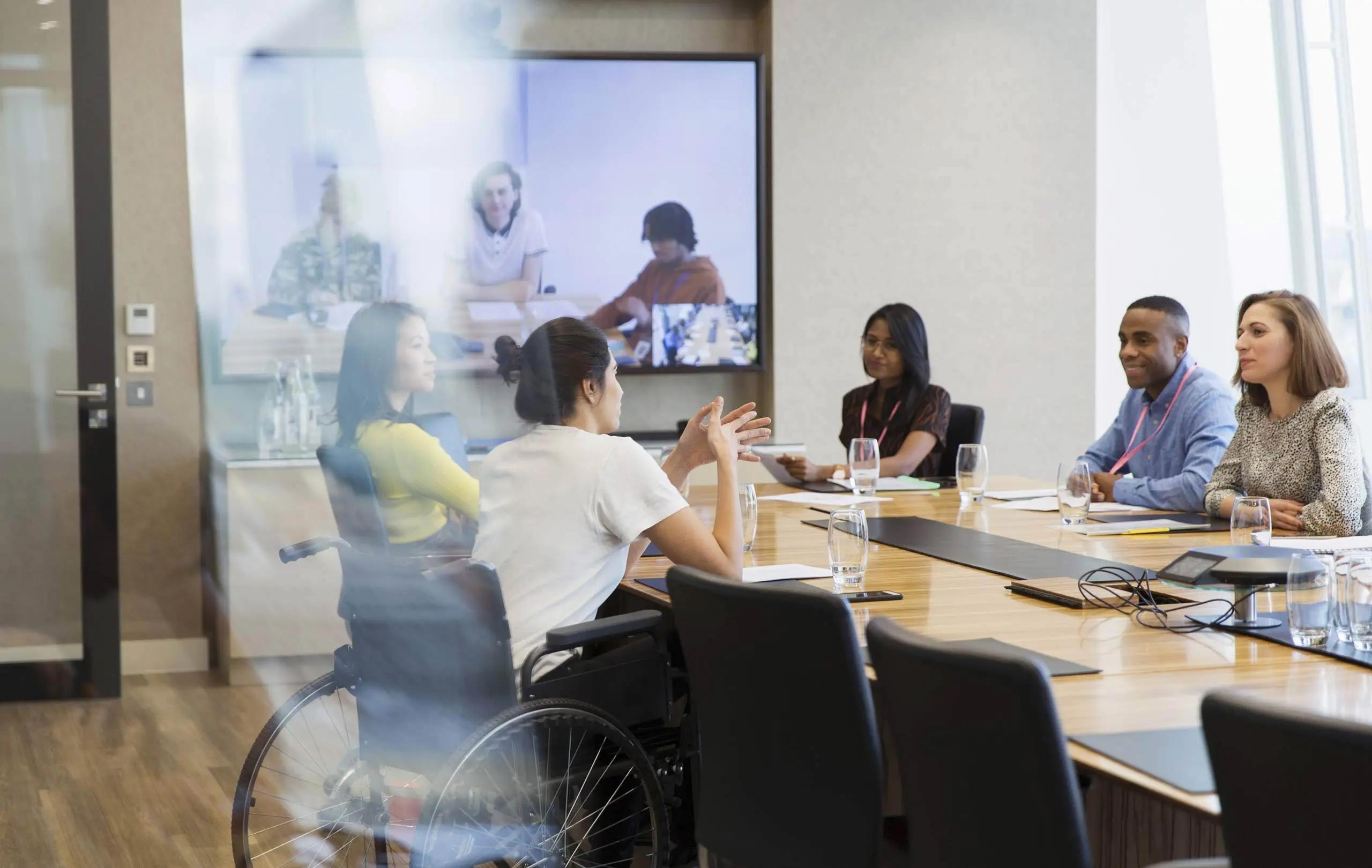 Group of coworkers sitting inside of a conference room.