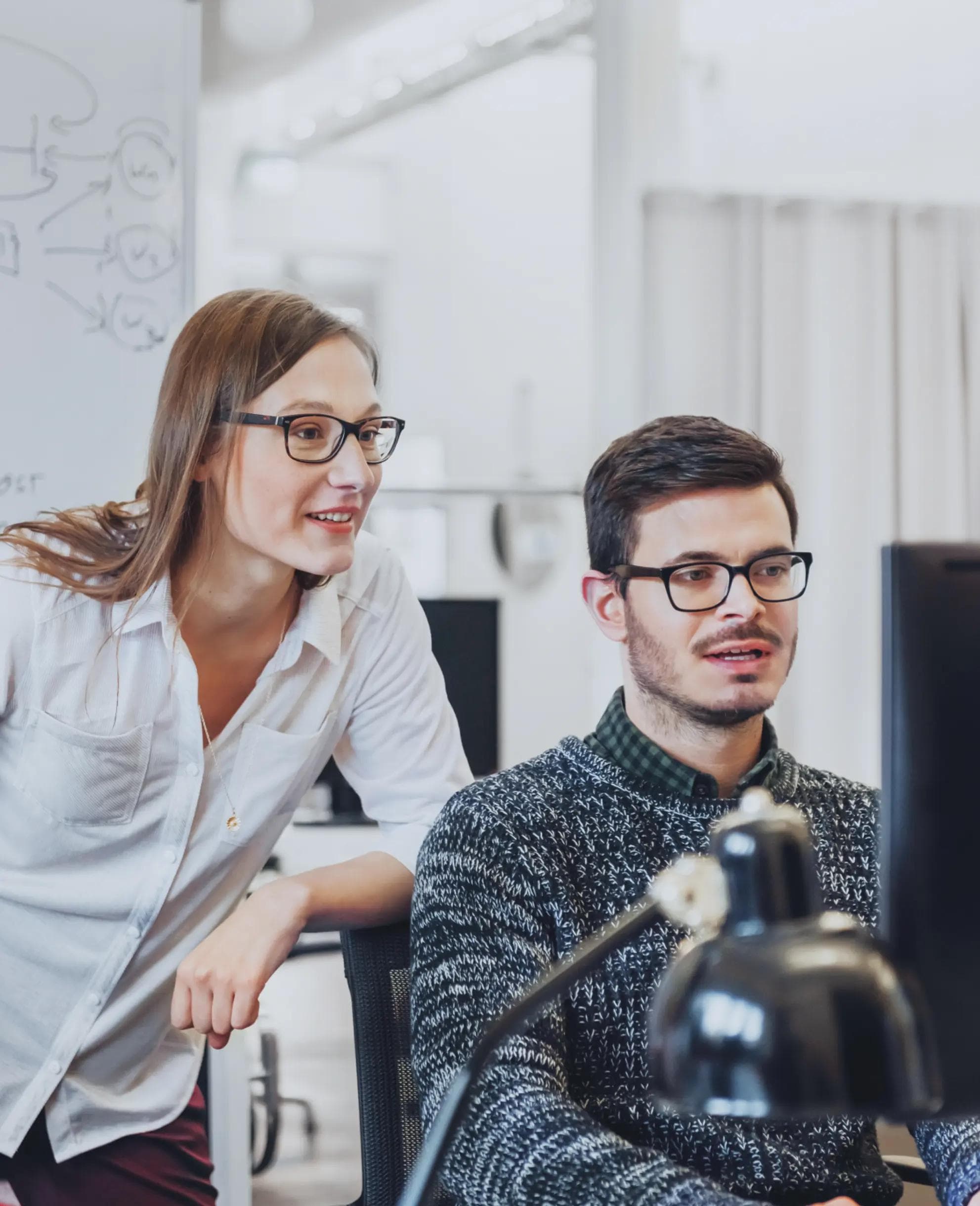Image of woman working at a desk with a computer.